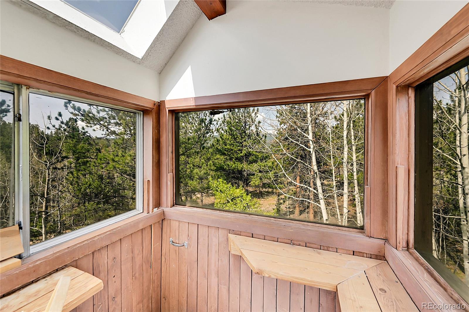 101 Campbell Road Bailey, CO 80421 - Photo 32 of 49 a view of an empty room with wooden floor and a window