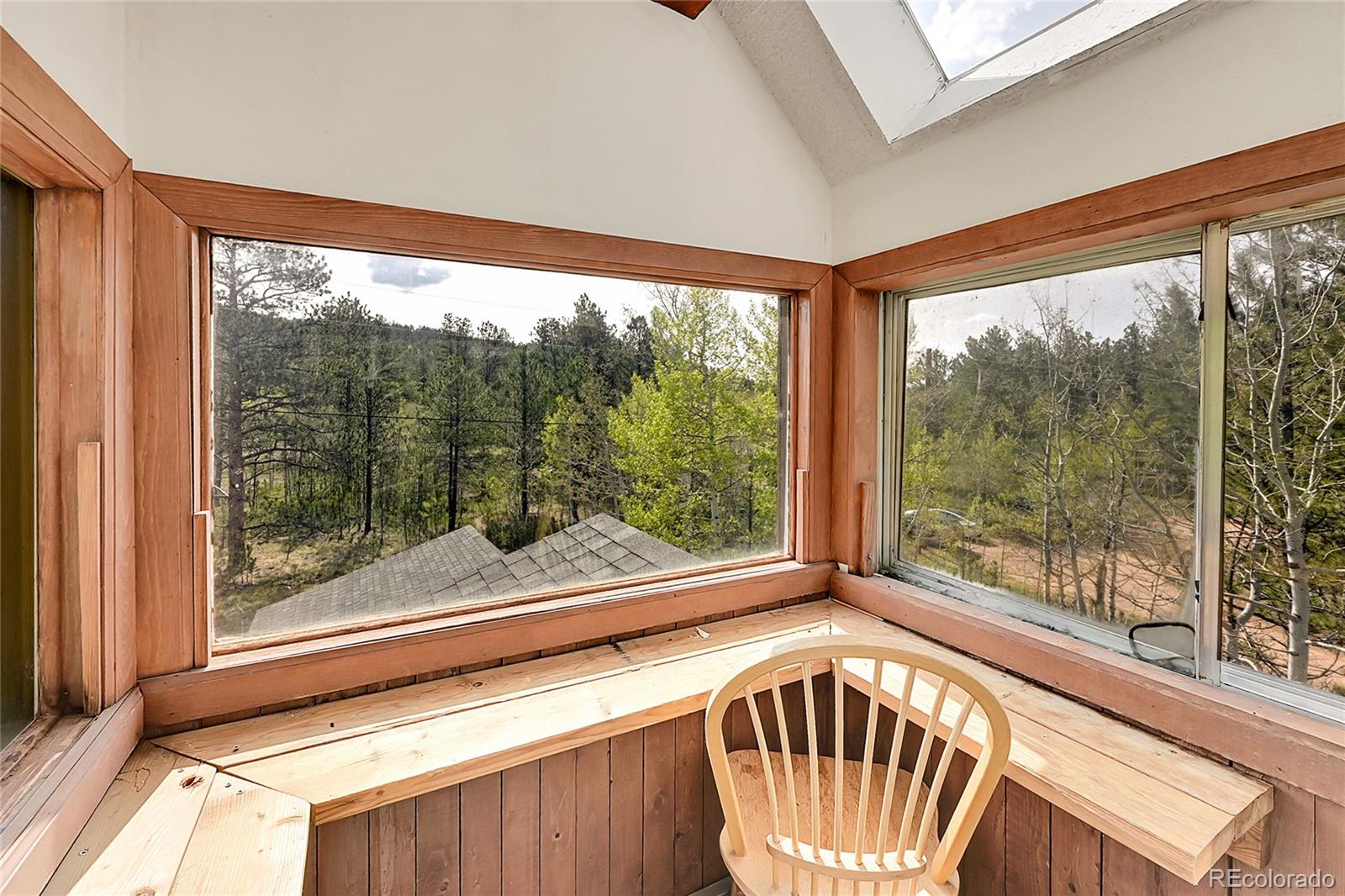 101 Campbell Road Bailey, CO 80421 - Photo 33 of 49 a view of a porch with furniture and front door