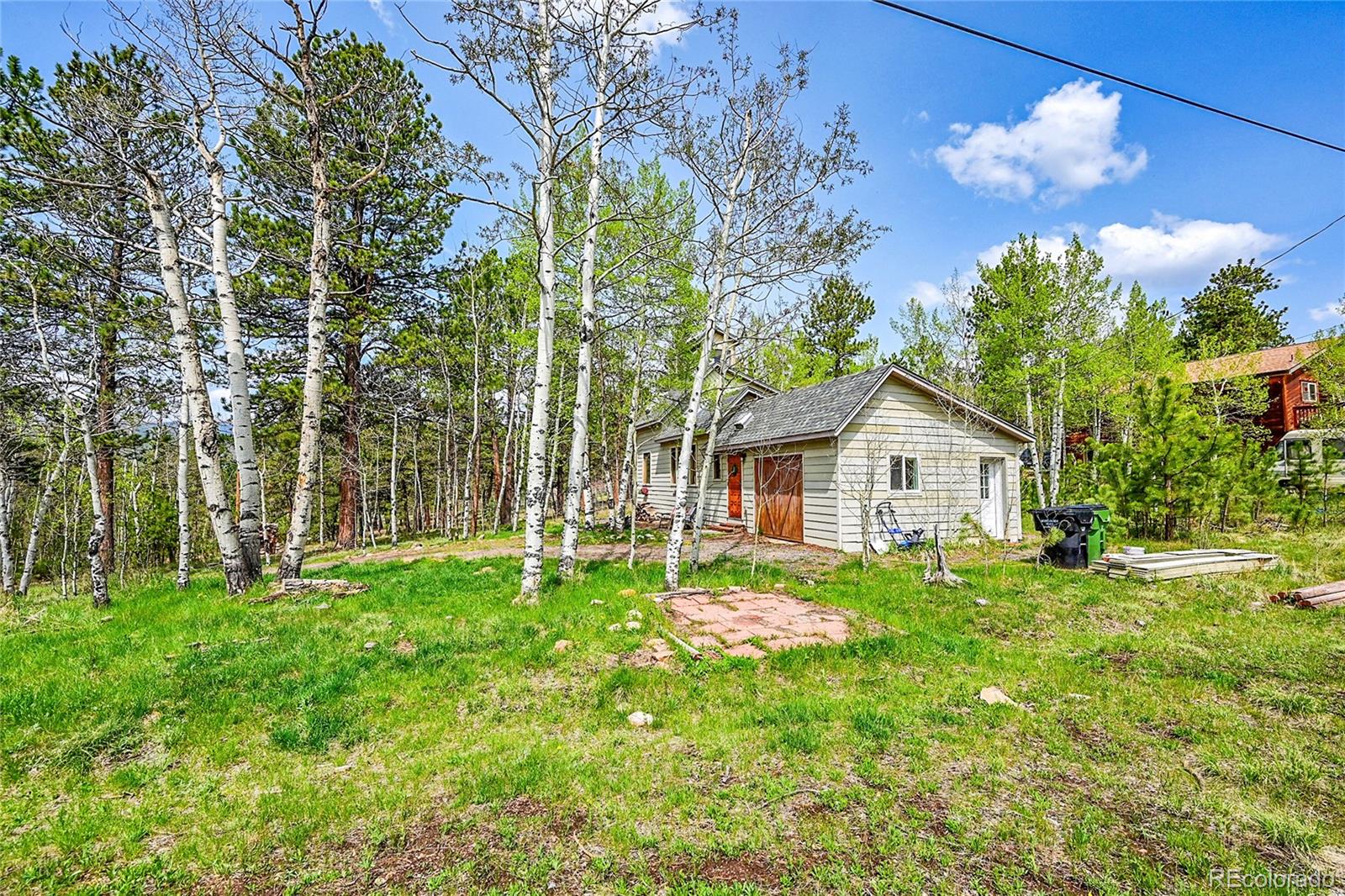 101 Campbell Road Bailey, CO 80421 - Photo 38 of 49 front view of a house with a yard
