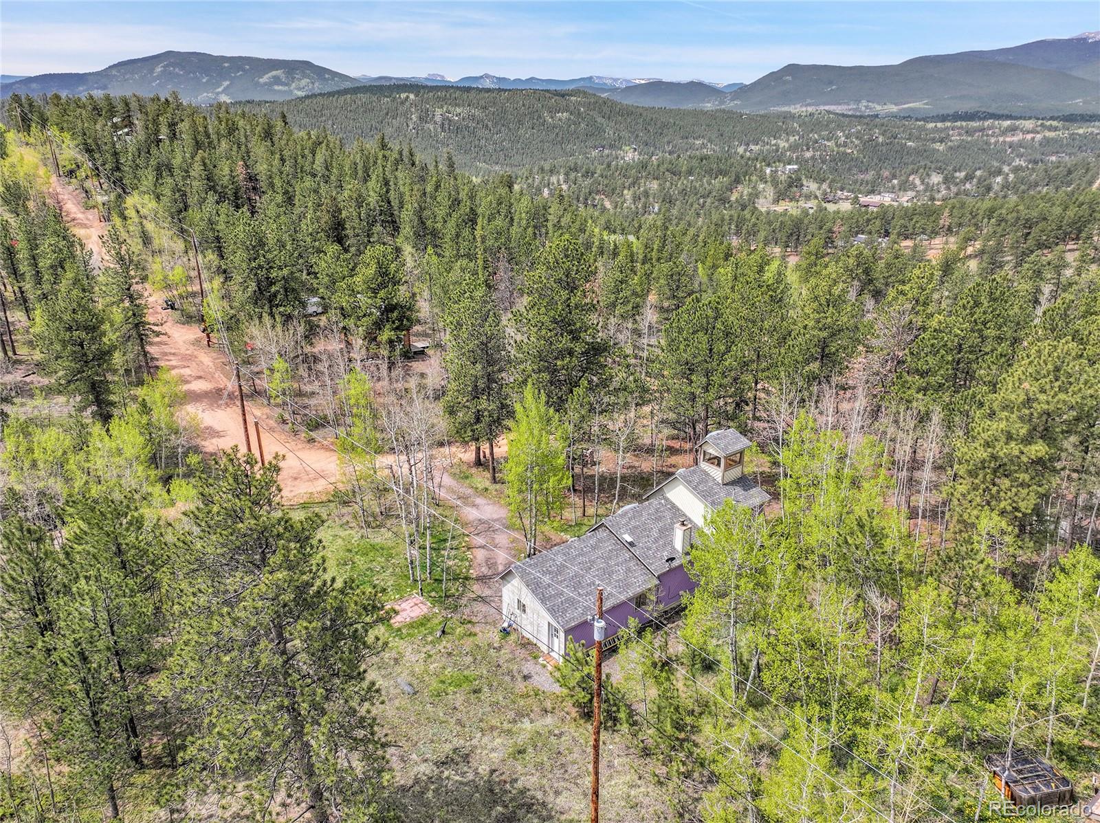 101 Campbell Road Bailey, CO 80421 - Photo 6 of 49 a view of a city with lush green forest