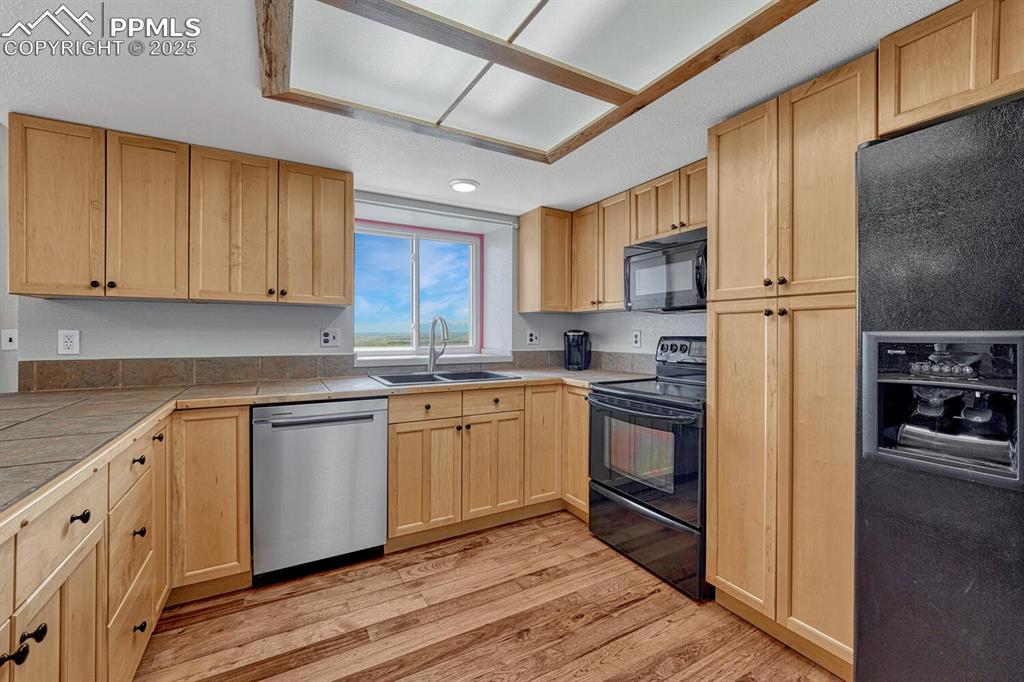 7550 Soap Weed Road Calhan, CO 80808 - Photo 12 of 50 a kitchen with stainless steel appliances granite countertop a stove a sink and a refrigerator