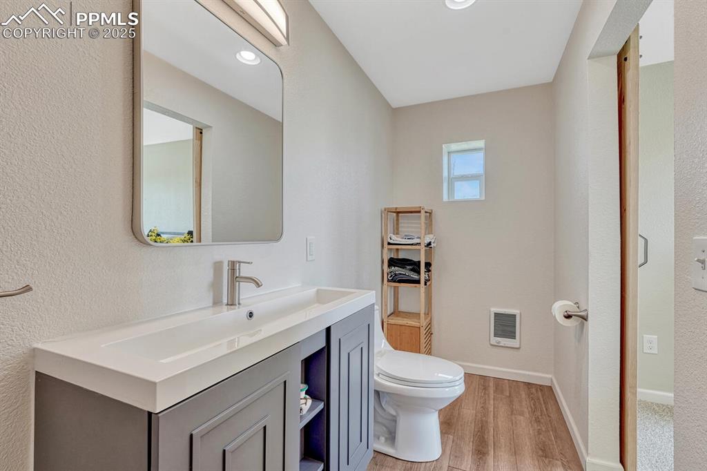7550 Soap Weed Road Calhan, CO 80808 - Photo 38 of 50 a bathroom with a sink toilet vanity and shower