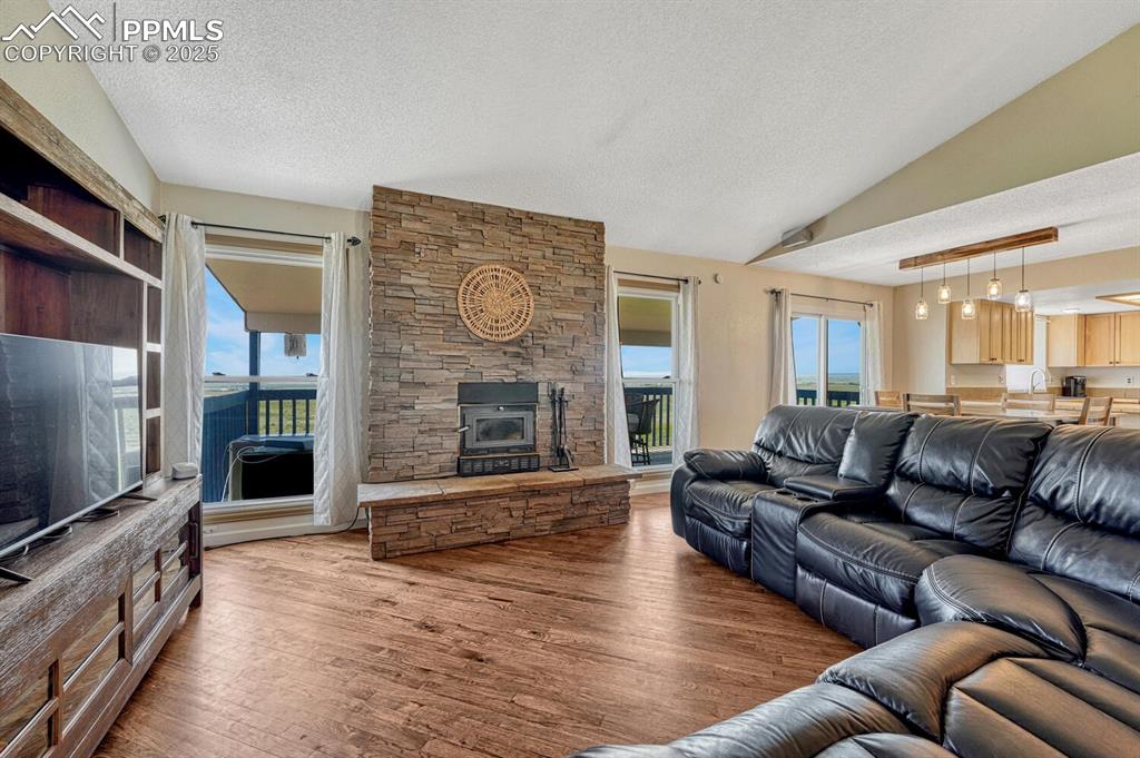 7550 Soap Weed Road Calhan, CO 80808 - Photo 5 of 50 a living room with fireplace furniture and a flat screen tv