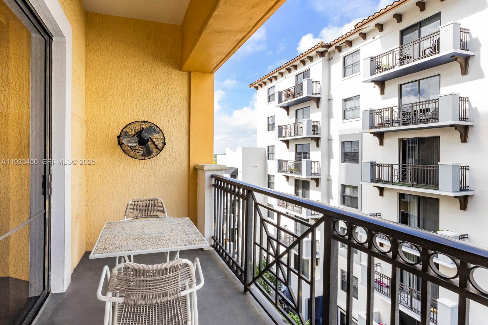 8395 Southwest 73rd Avenue, Unit 521 Miami, FL 33143 - Photo 5 of 21 a view of a balcony with a table and chairs