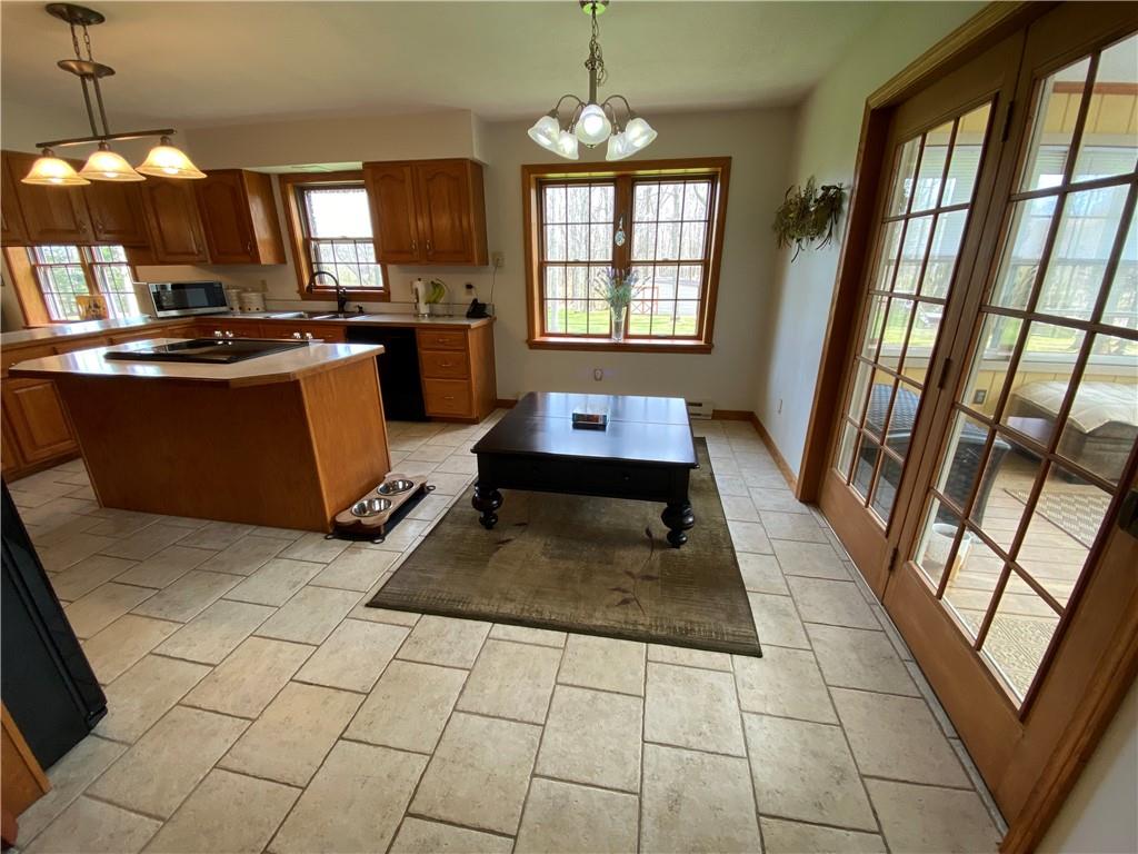 202 West Methodist Road Greenville, PA 16125 - Photo 11 of 25 a kitchen with granite countertop a stove a sink a counter space and wooden floor