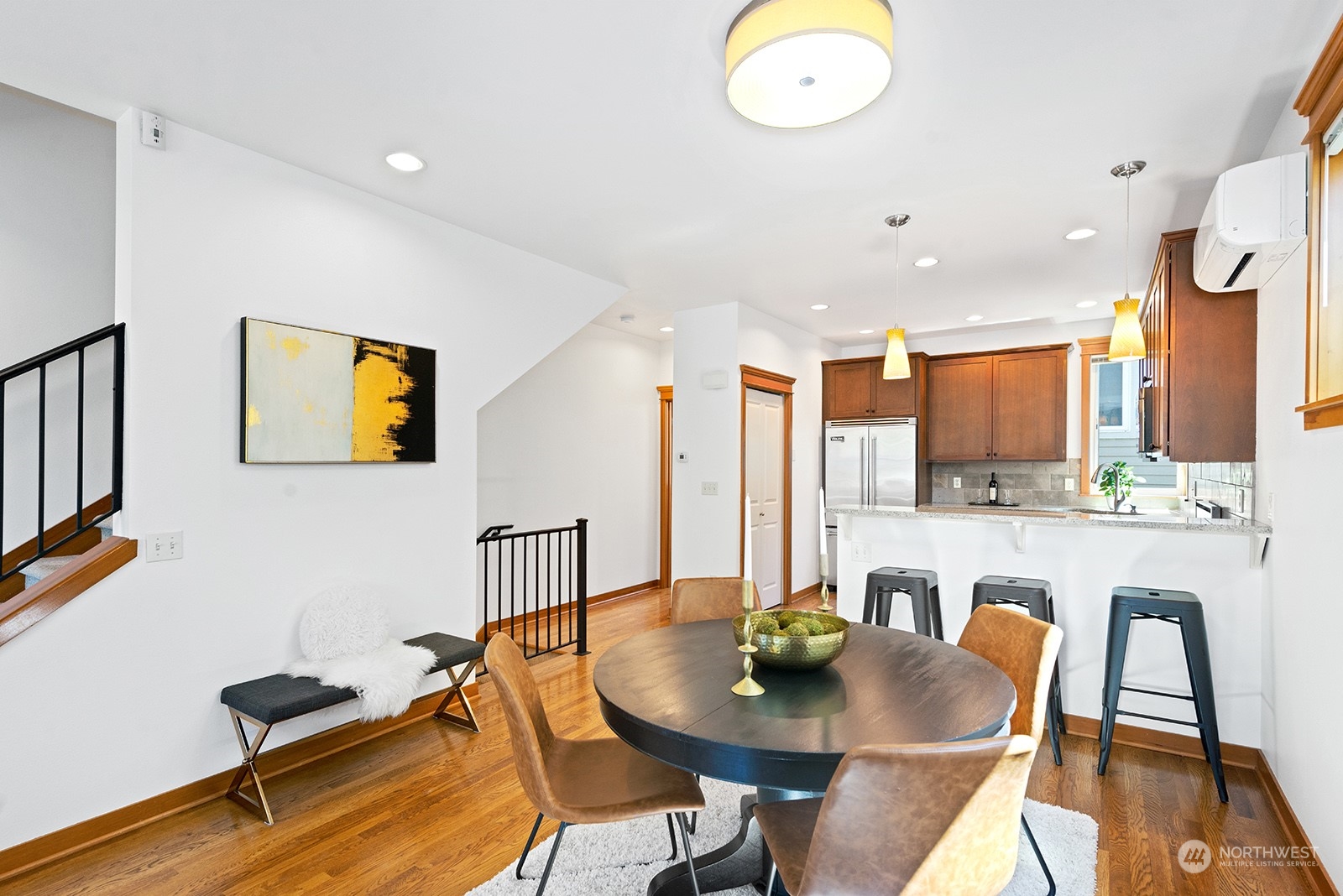 4309 Southwest Seattle Street Seattle, WA 98116 - Photo 11 of 36 a kitchen with stainless steel appliances granite countertop a table and chairs