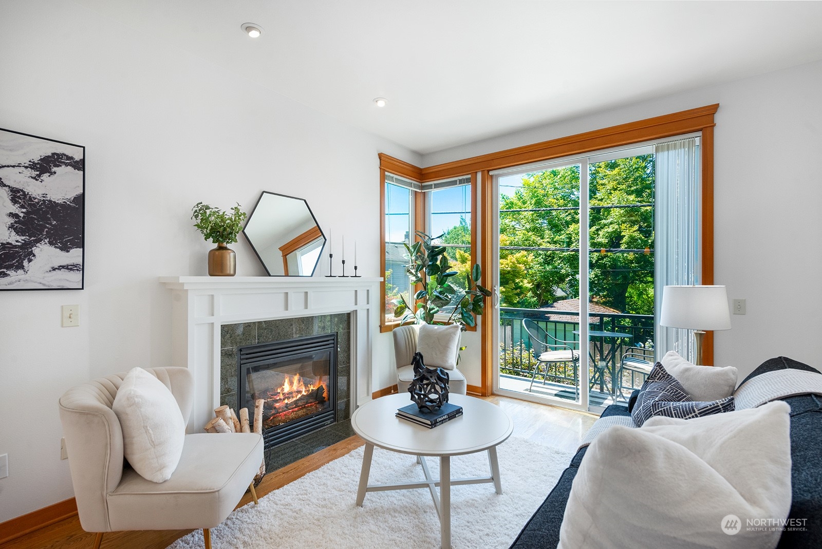 4309 Southwest Seattle Street Seattle, WA 98116 - Photo 15 of 36 a living room with furniture a fireplace and a floor to ceiling window