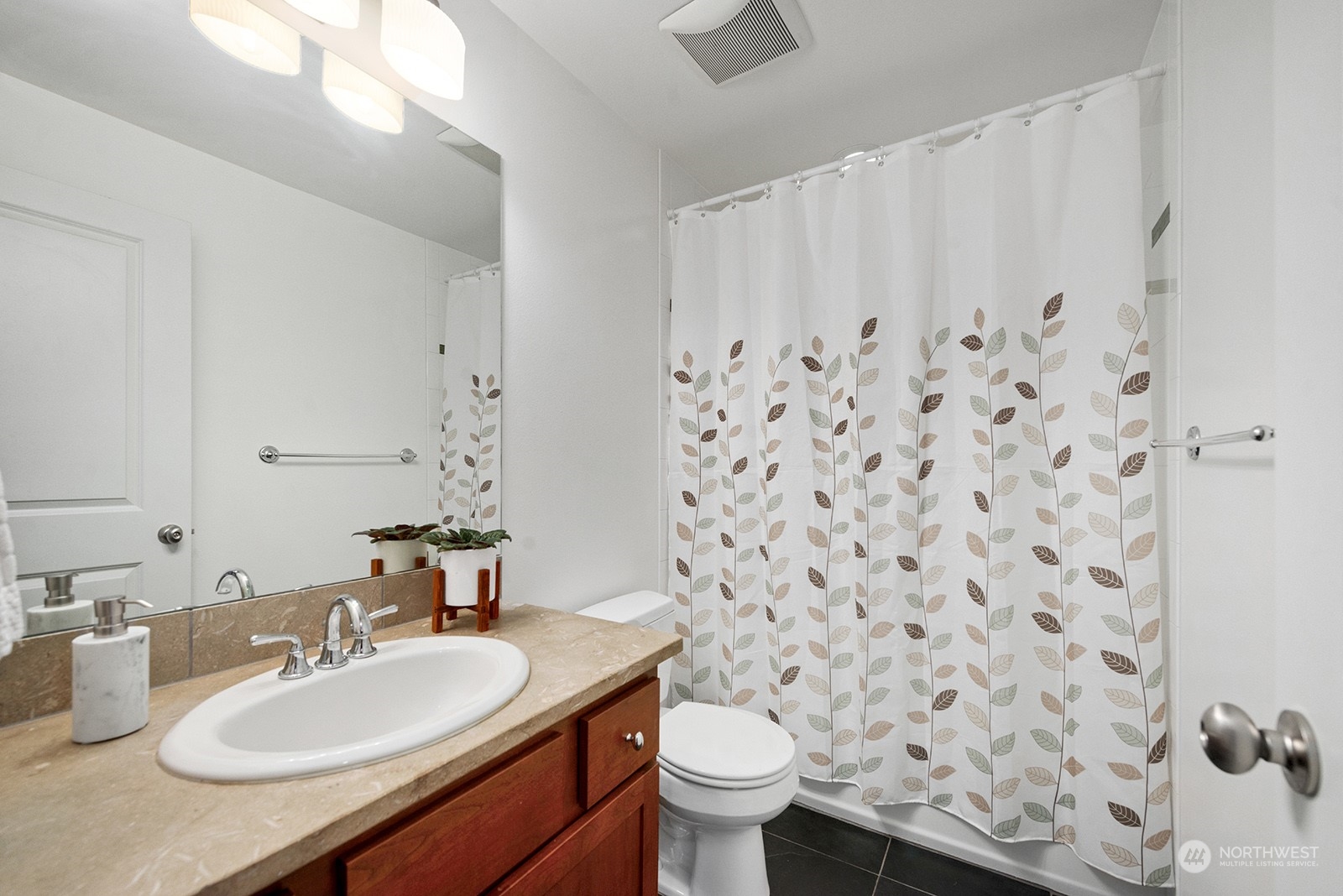 4309 Southwest Seattle Street Seattle, WA 98116 - Photo 27 of 36 a bathroom with a granite countertop sink mirror and toilet
