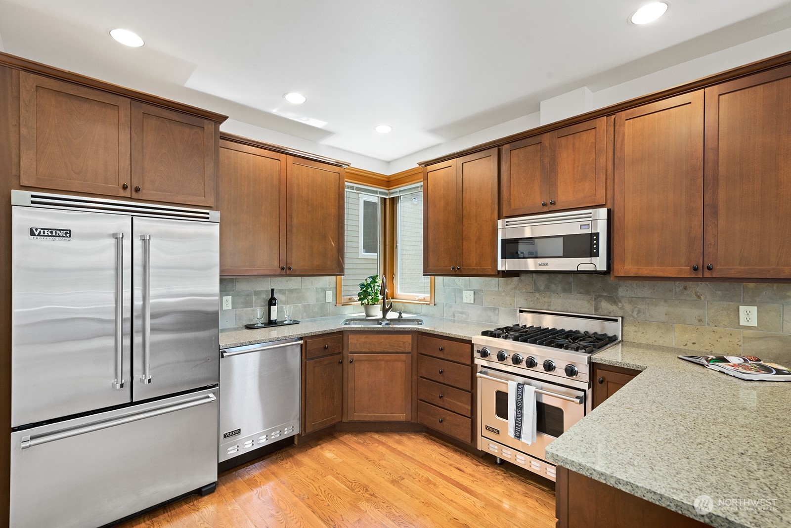4309 Southwest Seattle Street Seattle, WA 98116 - Photo 5 of 36 a kitchen with stainless steel appliances granite countertop a refrigerator sink and cabinets