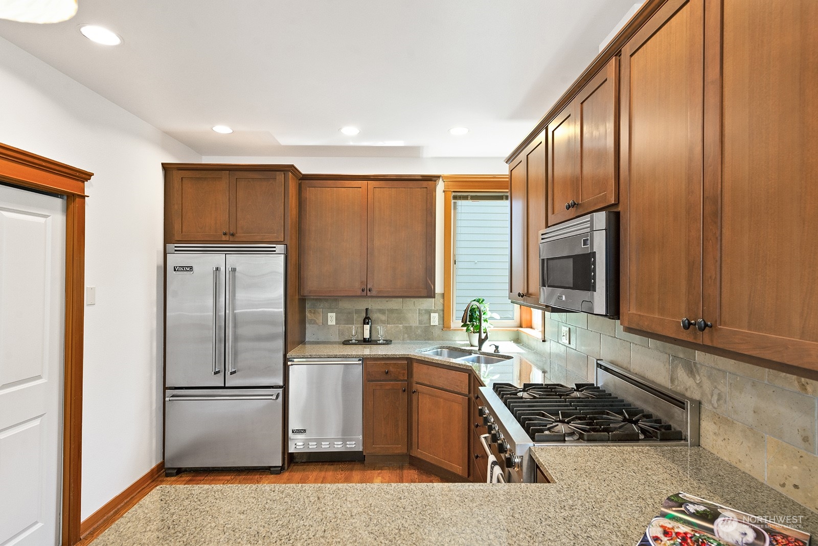4309 Southwest Seattle Street Seattle, WA 98116 - Photo 6 of 36 a kitchen with a sink a refrigerator and cabinets