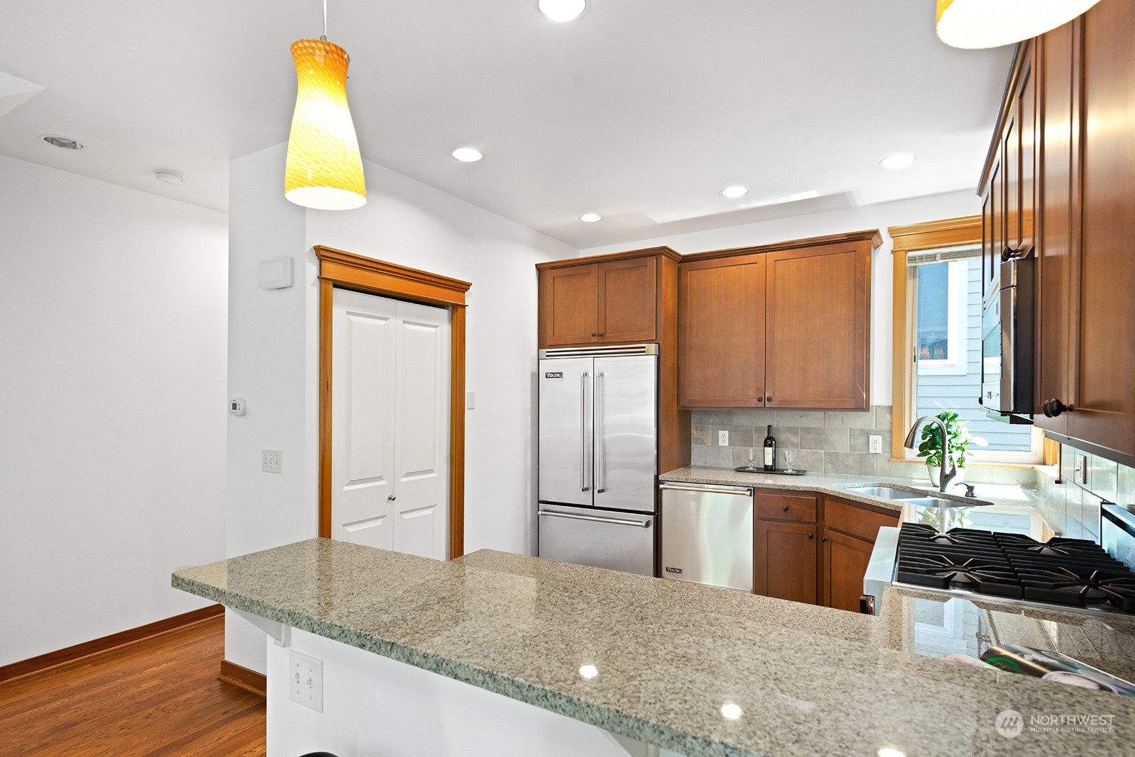 4309 Southwest Seattle Street Seattle, WA 98116 - Photo 7 of 36 a kitchen with stainless steel appliances granite countertop a sink stove and refrigerator