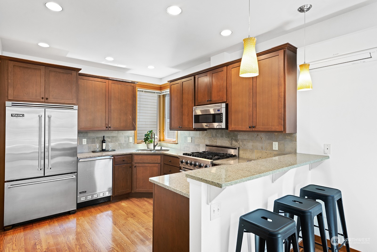 4309 Southwest Seattle Street Seattle, WA 98116 - Photo 8 of 36 a kitchen with a sink cabinets and stainless steel appliances