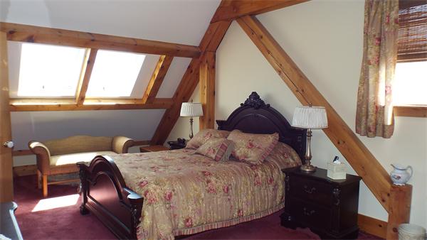 29 Potter Road Rowe, MA 01367 - Photo 17 of 30 a bed sitting in a bedroom next to a window