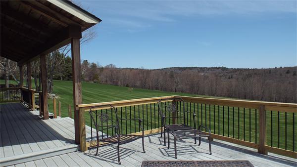 29 Potter Road Rowe, MA 01367 - Photo 3 of 30 a view of a chair and table on the wooden floor