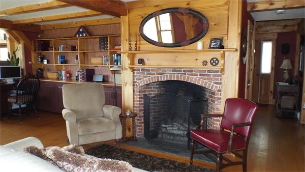 29 Potter Road Rowe, MA 01367 - Photo 6 of 30 a living room with furniture a rug a fireplace and a large window