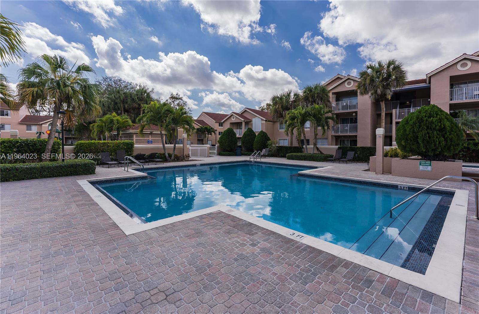 10521 Southwest 157th Place, Unit 102 Miami, FL 33196 - Photo 13 of 15 a swimming pool with outdoor seating and yard