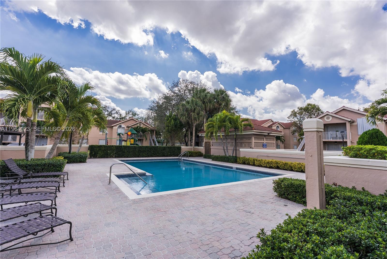 10521 Southwest 157th Place, Unit 102 Miami, FL 33196 - Photo 14 of 15 a view of a swimming pool with a patio