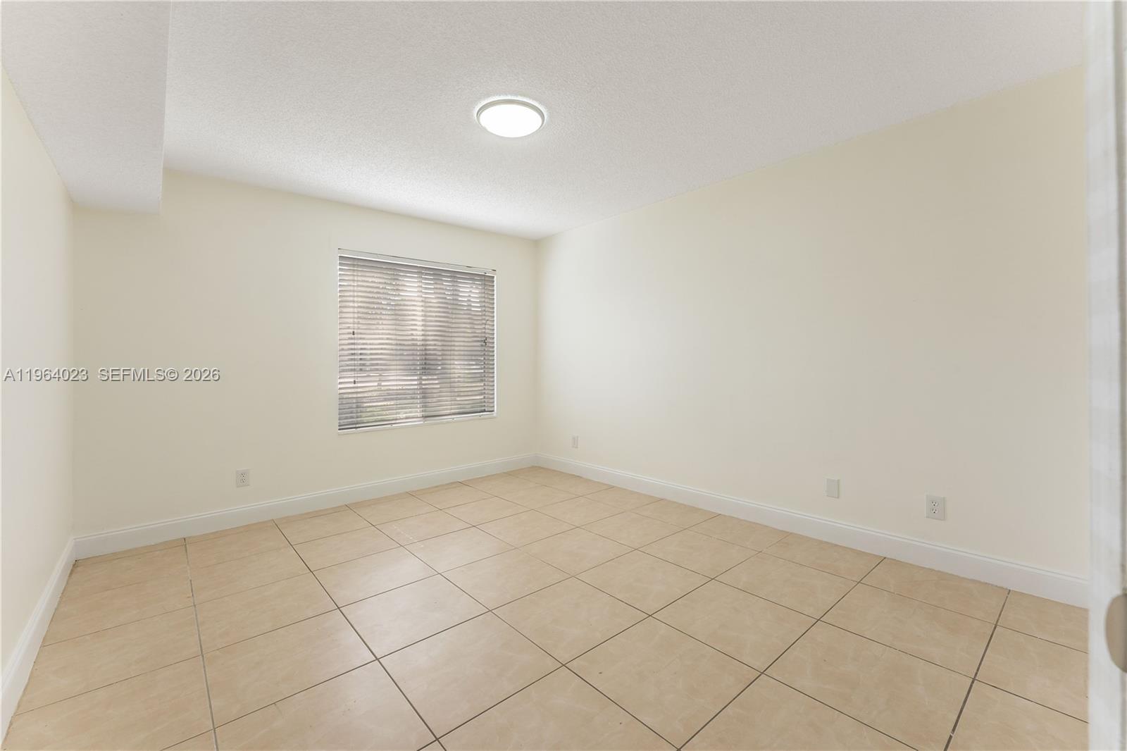 10521 Southwest 157th Place, Unit 102 Miami, FL 33196 - Photo 7 of 15 an empty room with windows