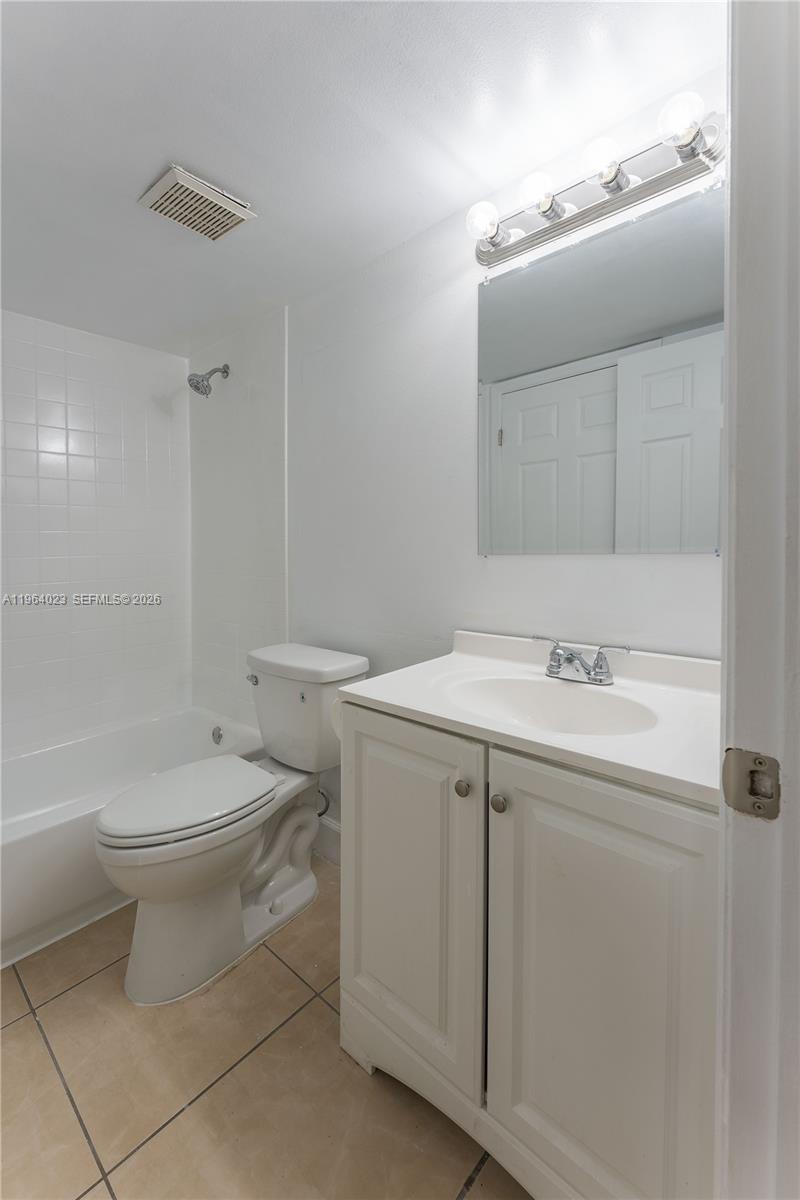 10521 Southwest 157th Place, Unit 102 Miami, FL 33196 - Photo 8 of 15 a bathroom with a sink toilet and shower