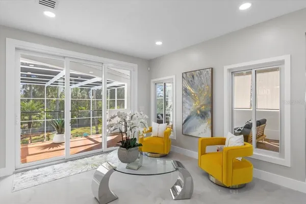 a living room with furniture and a potted plant