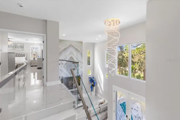 a bedroom with a bed and a chandelier