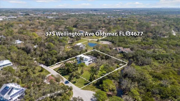 an aerial view of a house with a yard