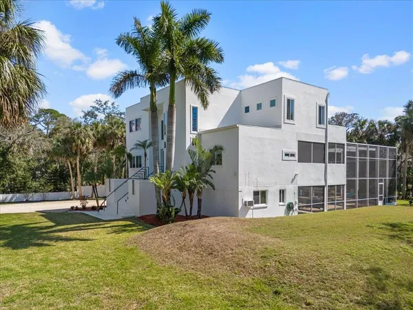 a view of a white house with a yard