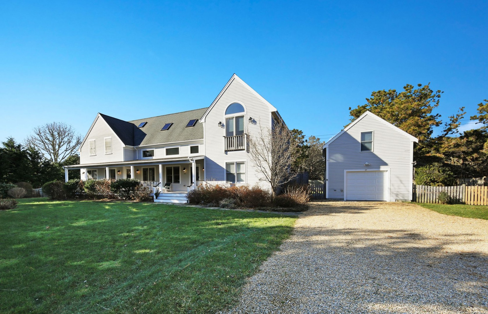 17 Thaxter Lane Edgartown, MA 02539 - Photo 1 of 23 a front view of a house with a yard and trees