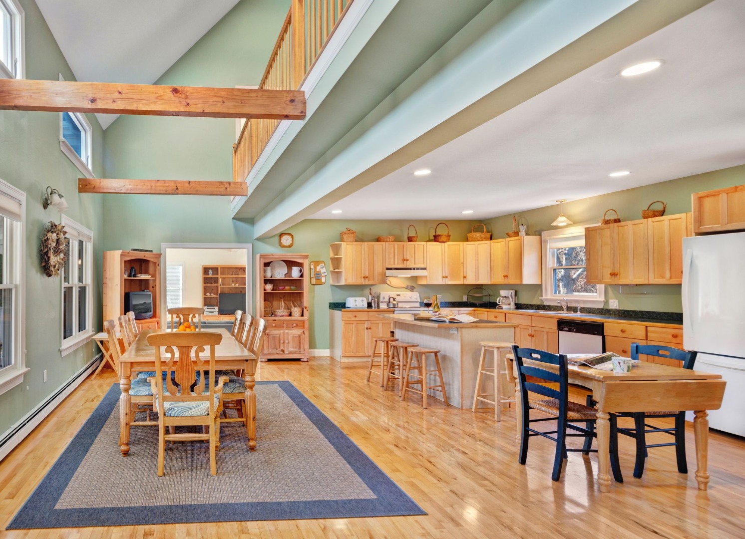 17 Thaxter Lane Edgartown, MA 02539 - Photo 6 of 23 a dining room with stainless steel appliances a table and chairs with wooden floor