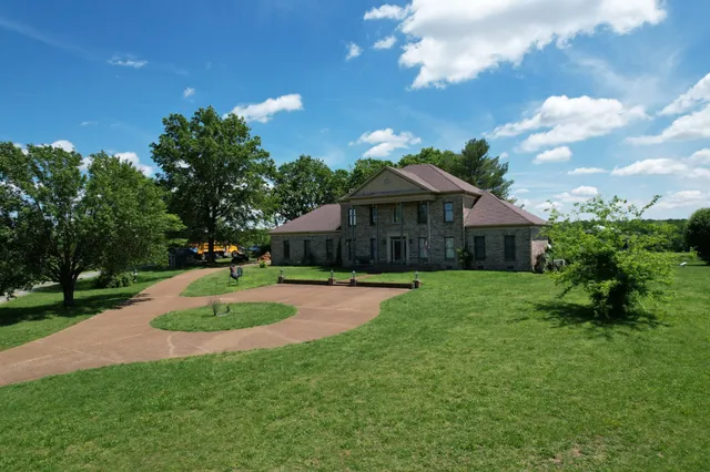 a front view of a house with a yard fire pit and outdoor seating