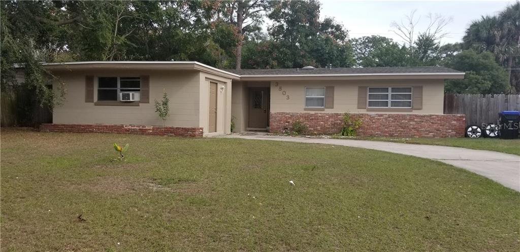 3803 Mitchell Road Orlando, FL 32808 - Photo 1 of 1 a front view of house with yard outdoor seating and green space