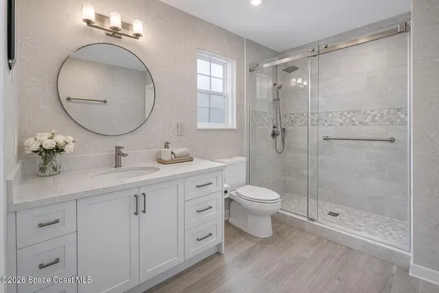 a bathroom with a shower and a sink
