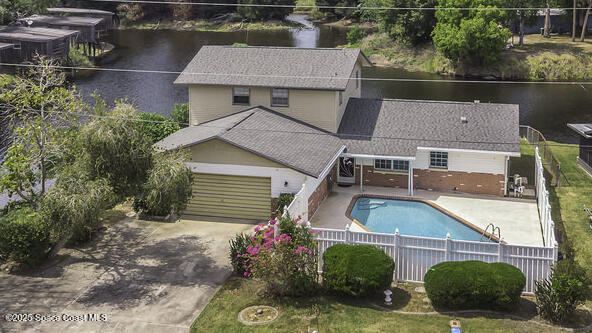 850 Cardinal Road Cocoa, FL 32926 - Photo 3 of 41 an aerial view of a house with a garden and lake view