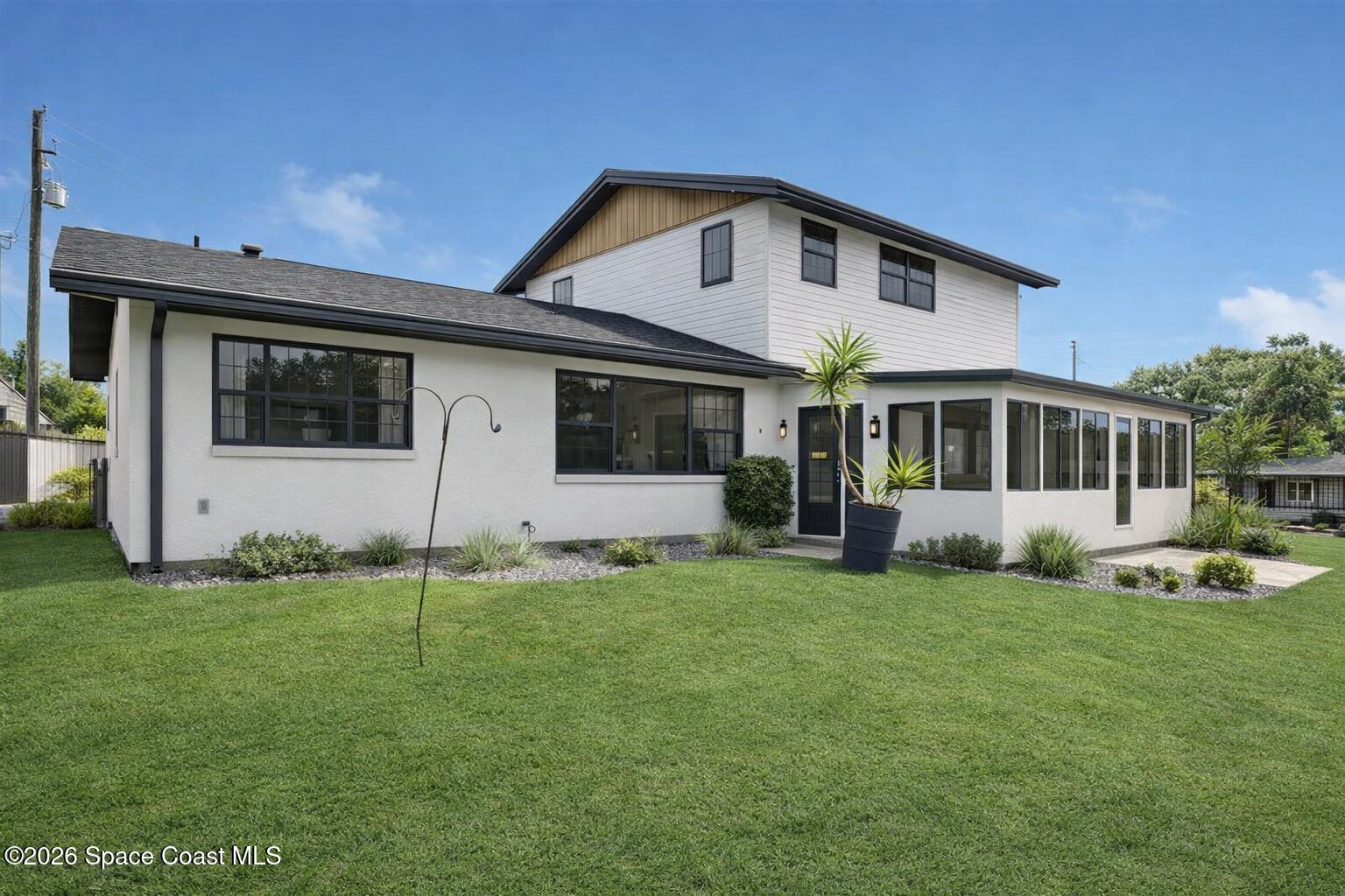 850 Cardinal Road Cocoa, FL 32926 - Photo 4 of 41 a front view of a house with a yard