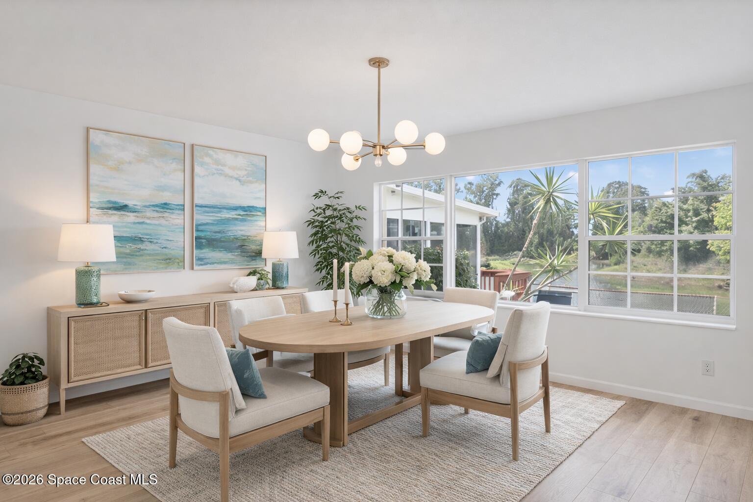 850 Cardinal Road Cocoa, FL 32926 - Photo 9 of 41 a dining room with furniture a chandelier and wooden floor