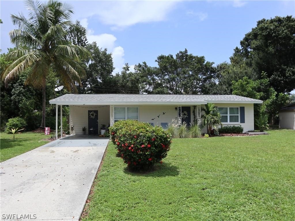 1453 Mandel Road Fort Myers, FL 33919 - Photo 1 of 16 a front view of a house with a garden and porch
