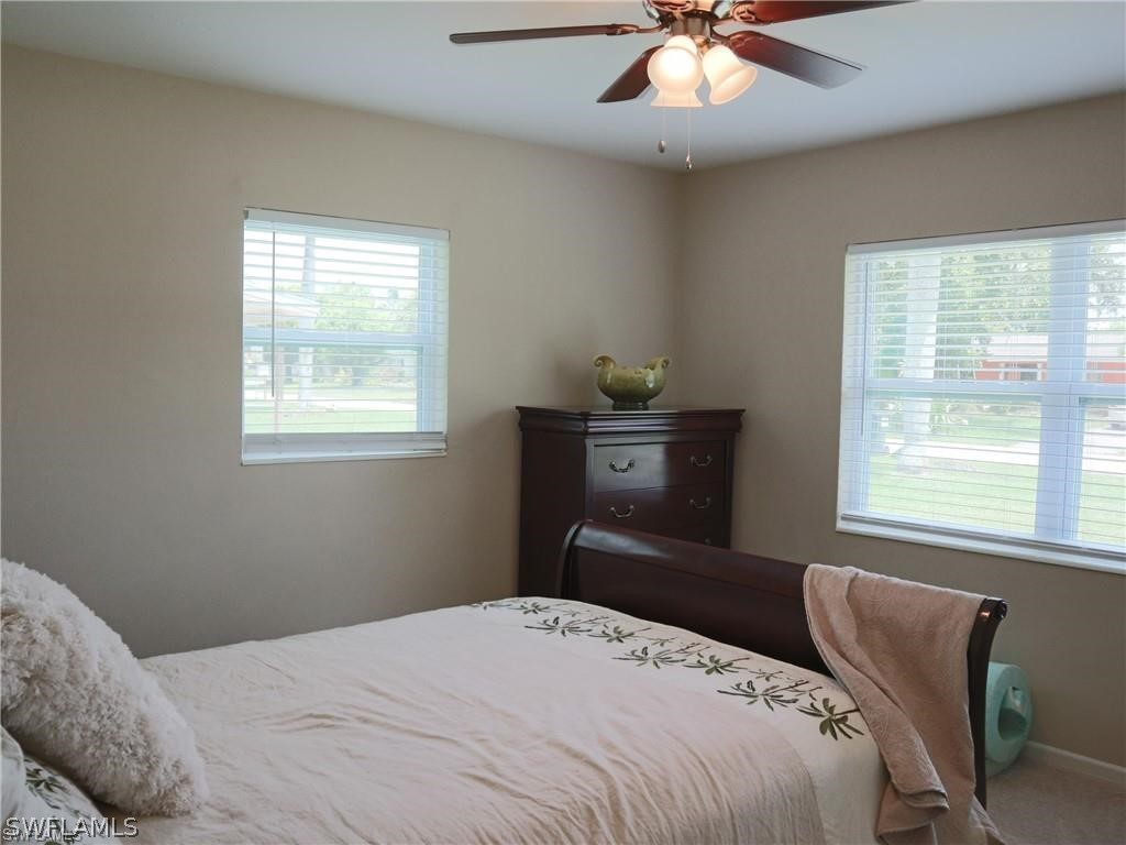 1453 Mandel Road Fort Myers, FL 33919 - Photo 11 of 16 a bedroom with a bed and a window