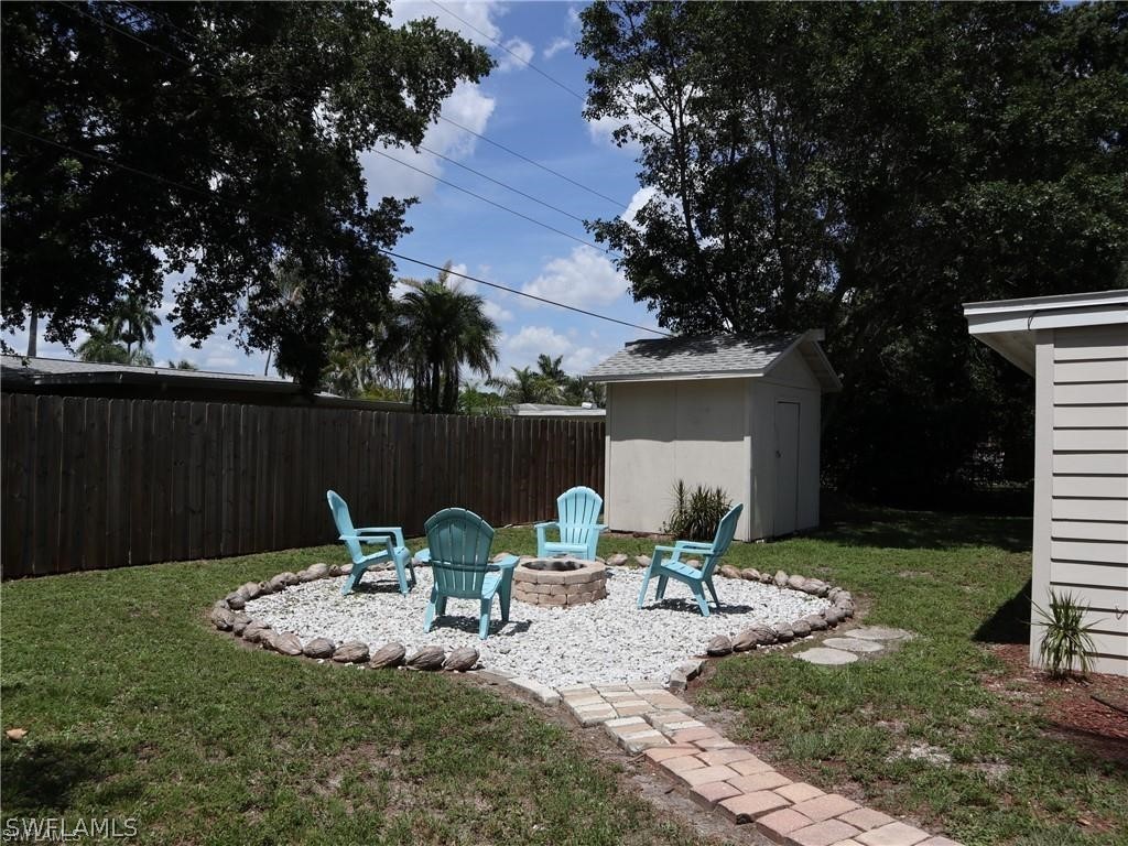 1453 Mandel Road Fort Myers, FL 33919 - Photo 16 of 16 a view of backyard with seating space and trees