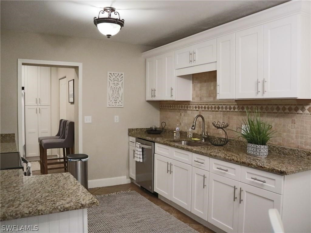 1453 Mandel Road Fort Myers, FL 33919 - Photo 5 of 16 a kitchen with granite countertop stainless steel appliances a sink stove and cabinets