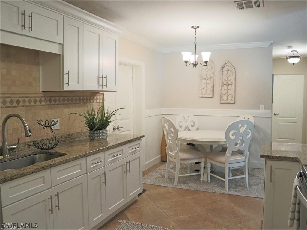 1453 Mandel Road Fort Myers, FL 33919 - Photo 6 of 16 a dining table with a sink and chandelier