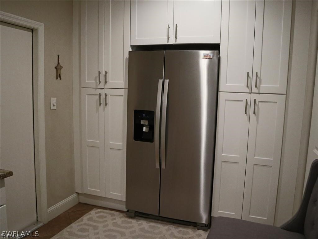1453 Mandel Road Fort Myers, FL 33919 - Photo 9 of 16 a view of kitchen with refrigerator and cabinet