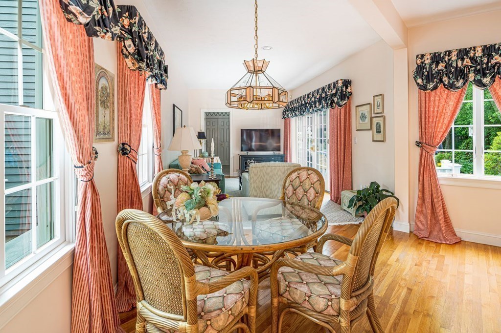 11 Forest Lane, Unit 11 Scituate, MA 02066 - Photo 12 of 39 a dining room with furniture a chandelier and wooden floor