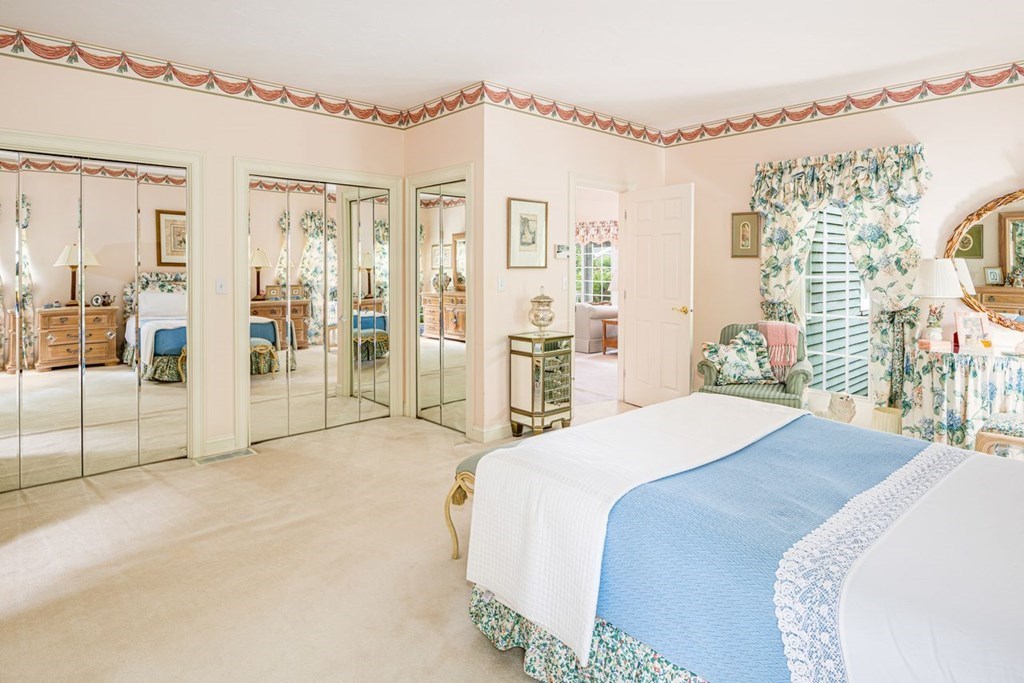 11 Forest Lane, Unit 11 Scituate, MA 02066 - Photo 19 of 39 a spacious bedroom with a large bed and a chandelier