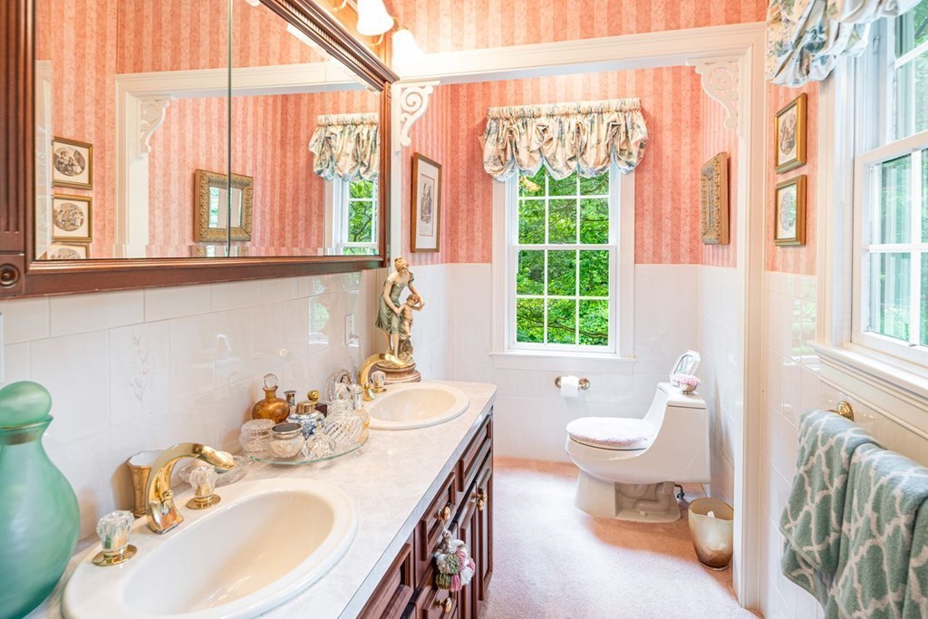 11 Forest Lane, Unit 11 Scituate, MA 02066 - Photo 20 of 39 a bathroom with a granite countertop sink and a large mirror next to a window