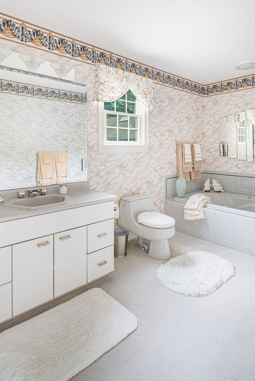 11 Forest Lane, Unit 11 Scituate, MA 02066 - Photo 26 of 39 a bathroom with a toilet a sink and a mirror