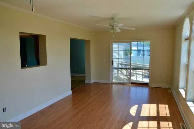 wooden floor in an empty room with a mirror