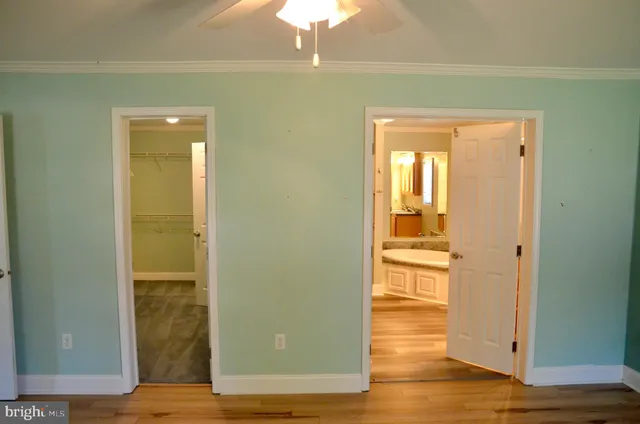 a bathroom with a tub a sink and a mirror