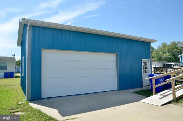 a view of a house with a yard and potted plants