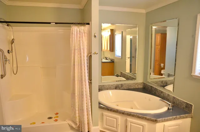 a bathroom with a granite countertop toilet and a shower