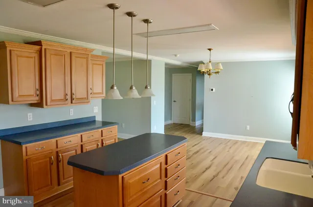 a view of empty room with wooden floor and ceiling fan